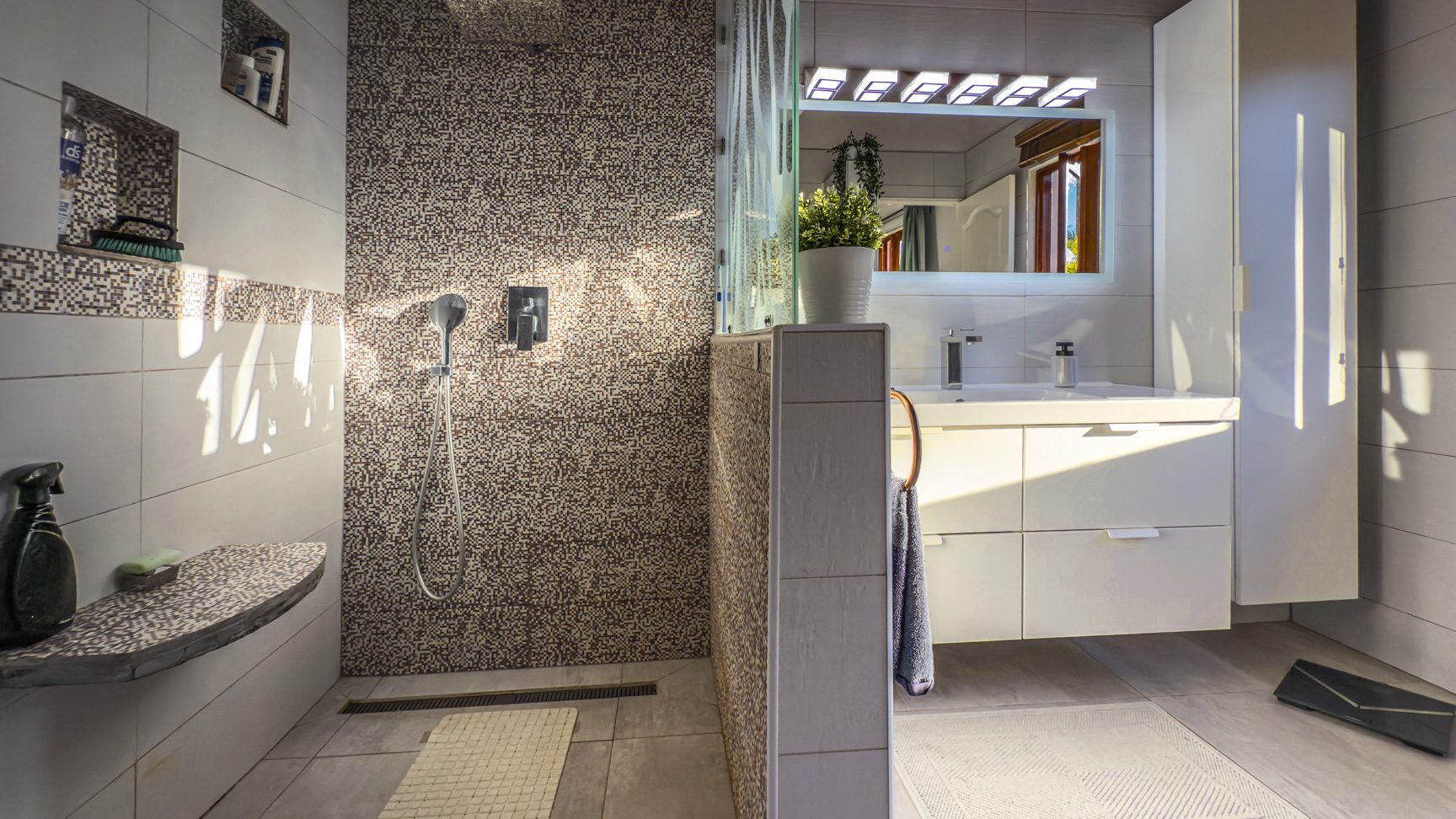 buyDRproperty Modern bathroom with walk-in shower and floating vanity, part of an Ocean View Villa. Sosua Real Estate