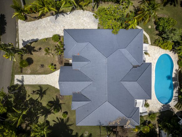 buyDRproperty Aerial view of a luxury home with a swimming pool and tropical landscaping Sosua Real Estate