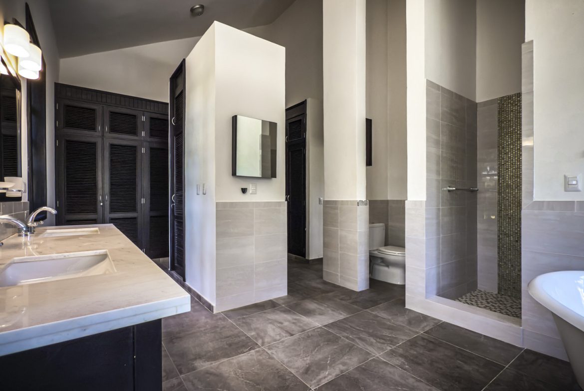 buyDRproperty Luxury bathroom with double vanity, walk-in shower, and freestanding tub. Sosua Real Estate