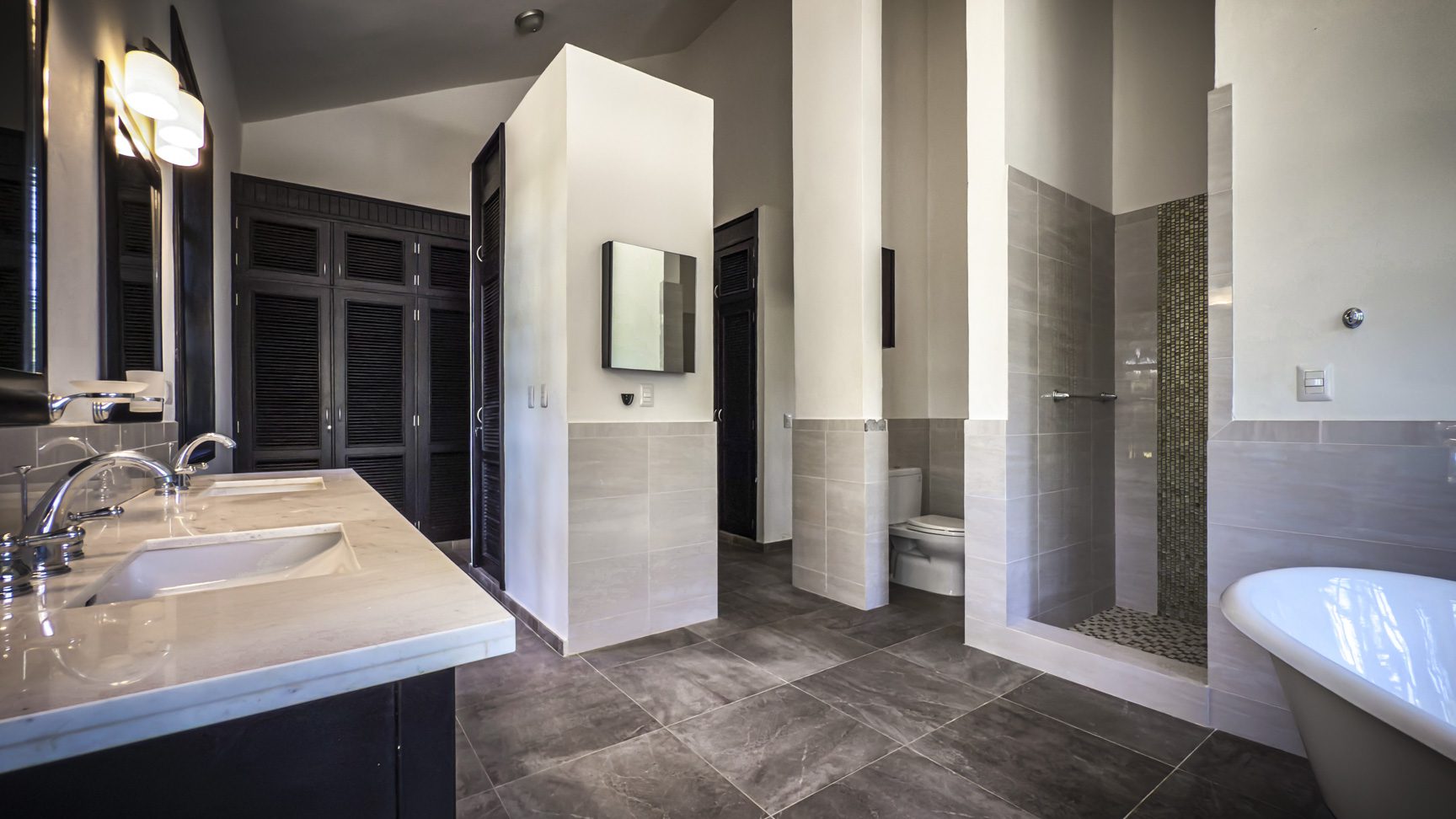 buyDRproperty Luxury bathroom with double vanity, walk-in shower, and freestanding tub. Sosua Real Estate