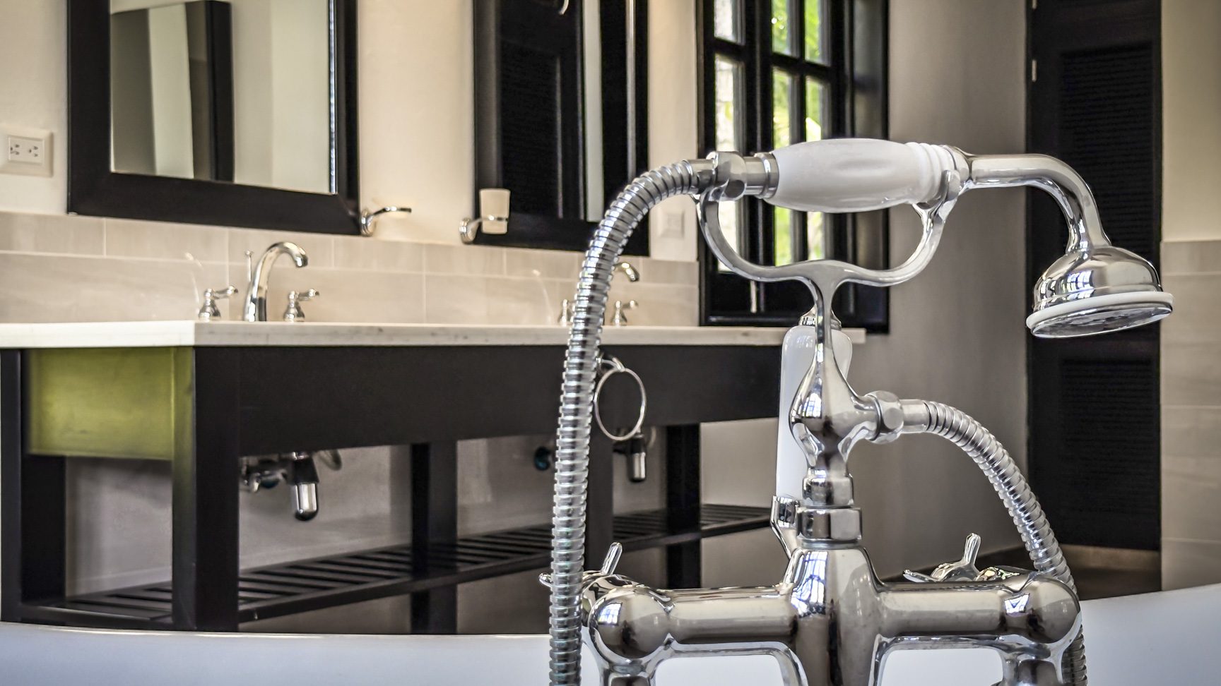 buyDRproperty Chrome shower fixture in a luxury bathroom with marble vanity and clawfoot tub Sosua Real Estate