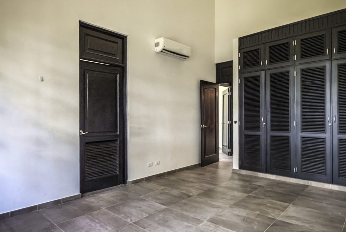 buyDRproperty Modern bedroom with dark wood closet and door, interior design Sosua Real Estate