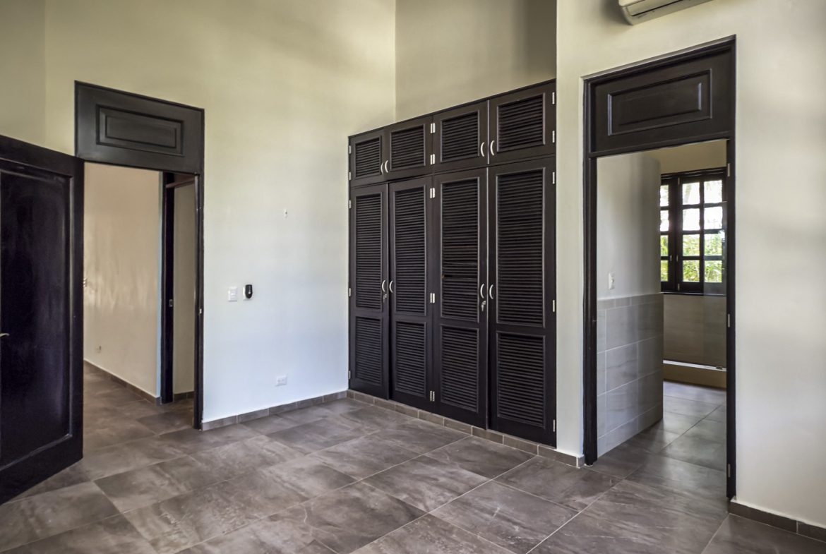 buyDRproperty Modern bedroom with dark wood closet and doors Sosua Real Estate