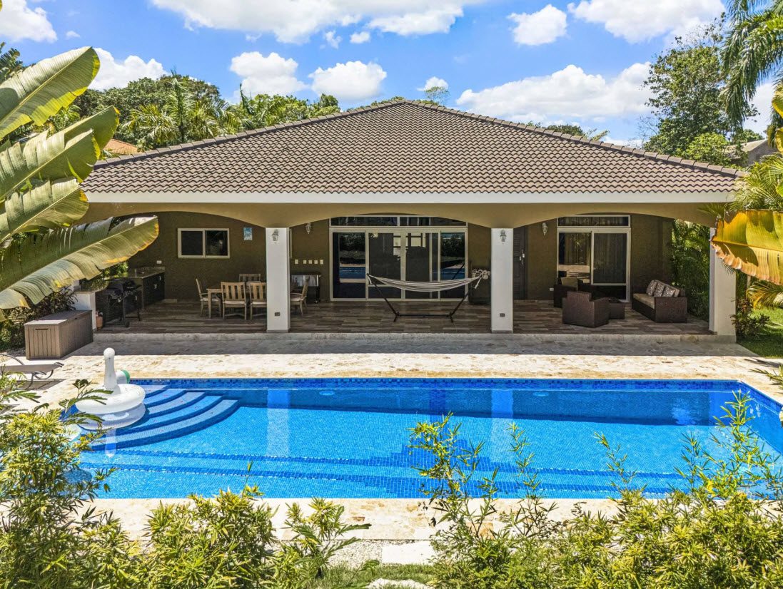 buyDRproperty Elegant villa with a pool and outdoor seating area. Sosua Real Estate