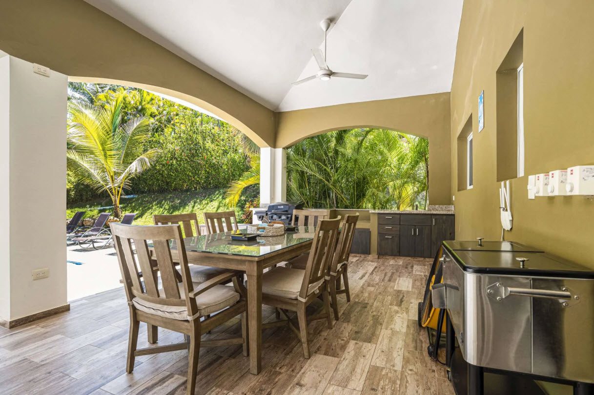 buyDRproperty Elegant outdoor dining area at Villa Lotus with a table set for a meal. Sosua Real Estate