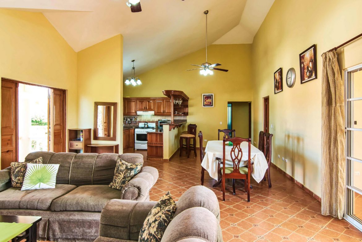 buyDRproperty Spacious living room with open kitchen in a Residential Hispaniola villa. Sosua Real Estate
