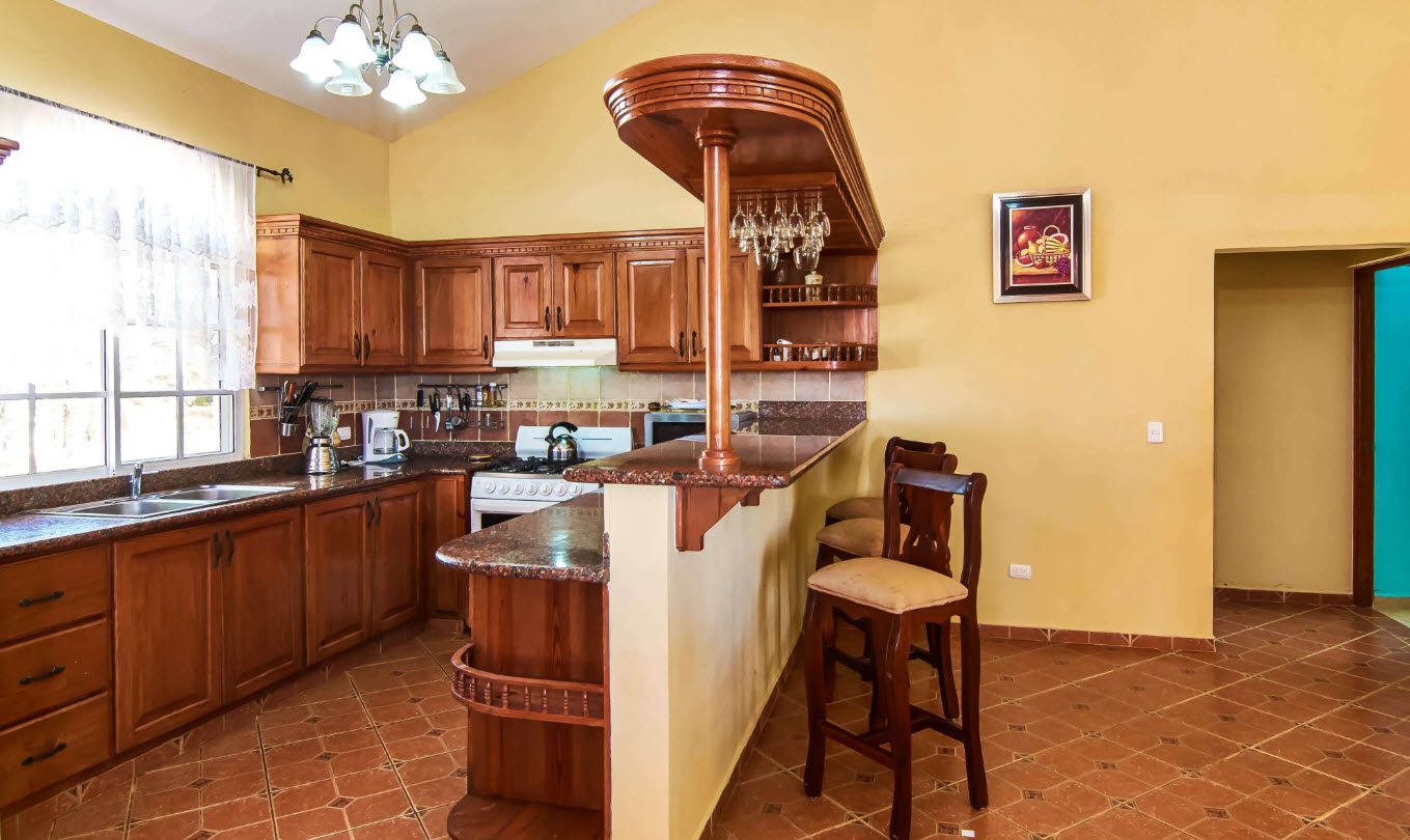 buyDRproperty Kitchen in a villa for sale at Residential Hispaniola with a bar and seating. Sosua Real Estate