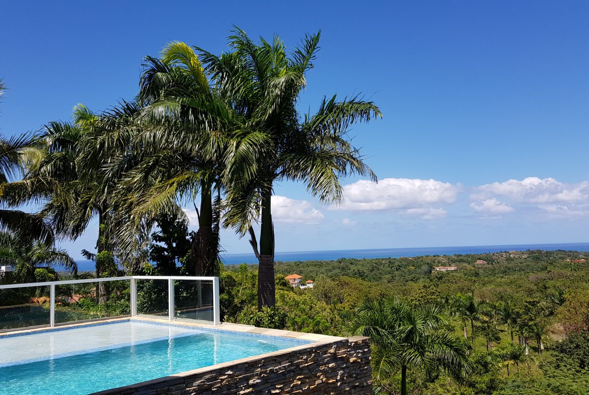 buyDRproperty Luxury villa with a swimming pool overlooking a tropical ocean view. Sosua Real Estate