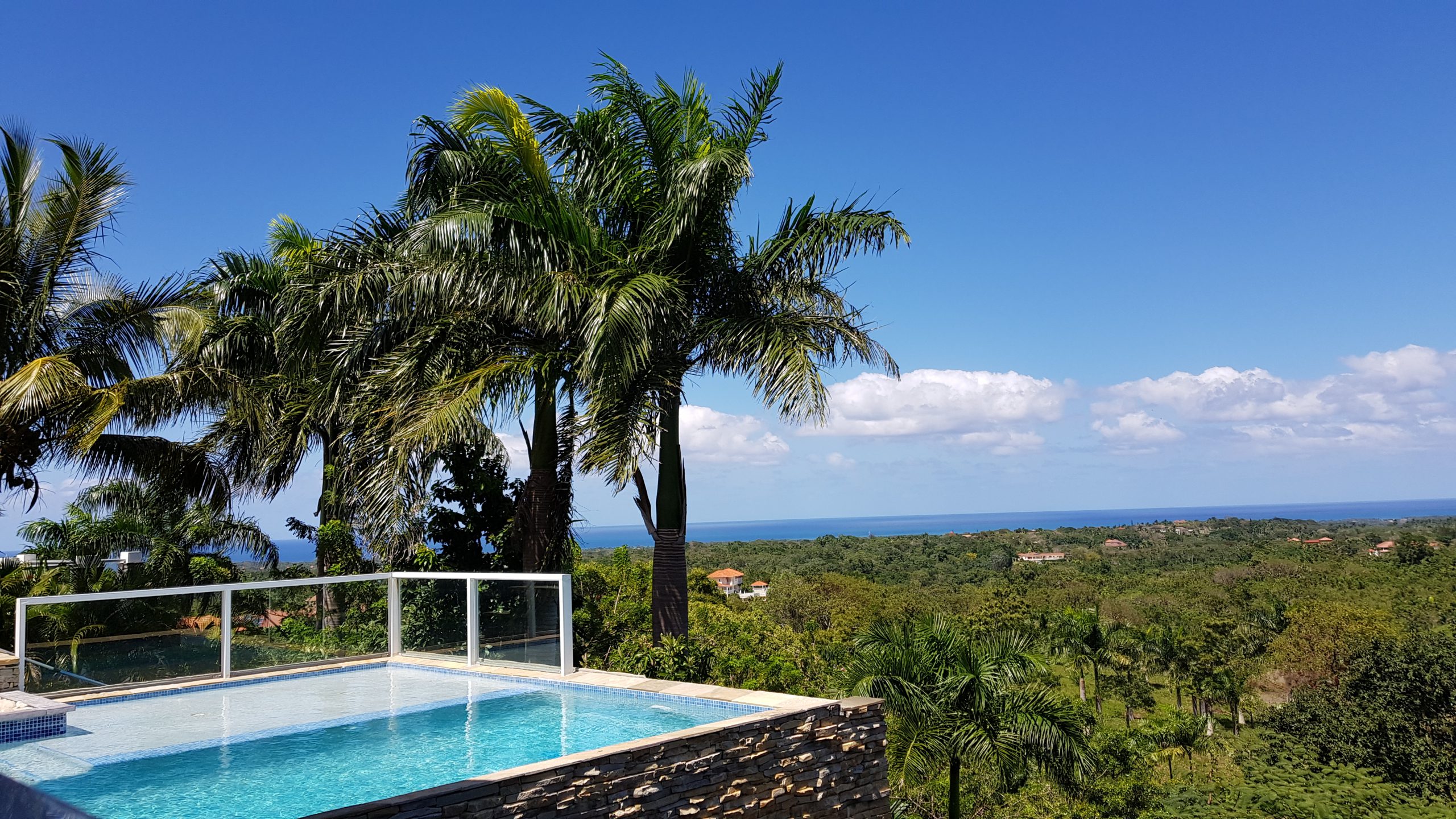 buyDRproperty Luxury villa with a swimming pool overlooking a tropical ocean view. Sosua Real Estate