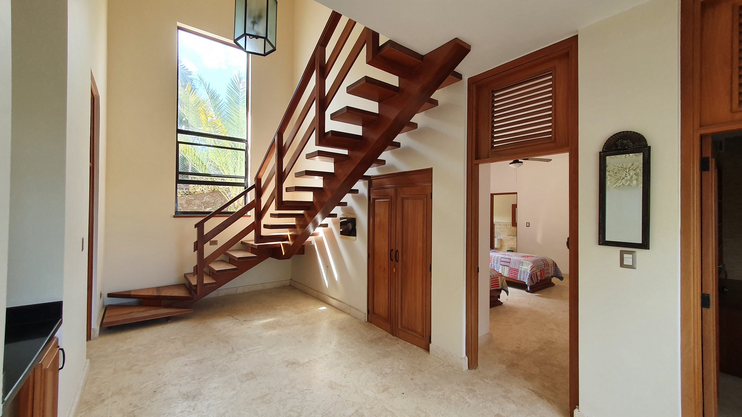 buyDRproperty Wooden staircase in a luxury home interior with natural light Sosua Real Estate