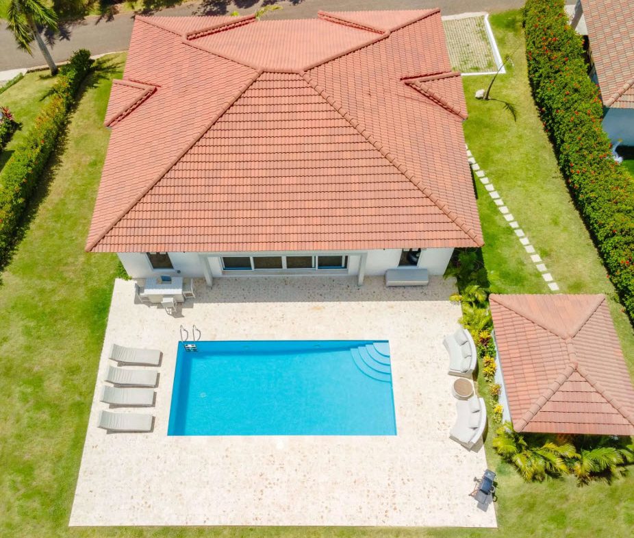 buyDRproperty Aerial view of a luxury villa with pool and red tile roof. Sosua Real Estate