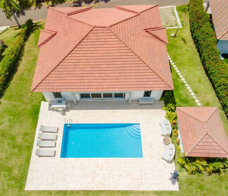 buyDRproperty Aerial view of a luxury villa with pool and red tile roof. Sosua Real Estate