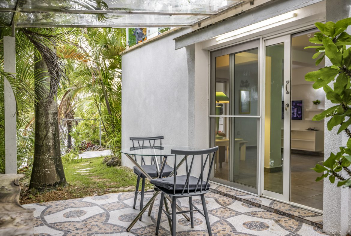 buyDRproperty Patio with table, chairs, and tropical garden view. Sosua Real Estate