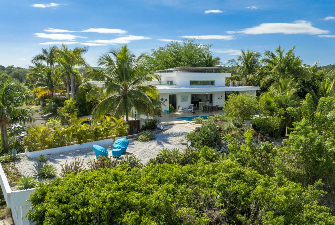 buyDRproperty Luxury villa with pool in Costa Rica, surrounded by tropical foliage. Sosua Real Estate