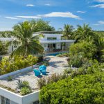 Buydrproperty Aerial View of a Modern White Villa with a Rooftop Garden Pool and Lush Tropical Landscaping Sosua Real Estate Buydrpropertycom Buydrpropertycom