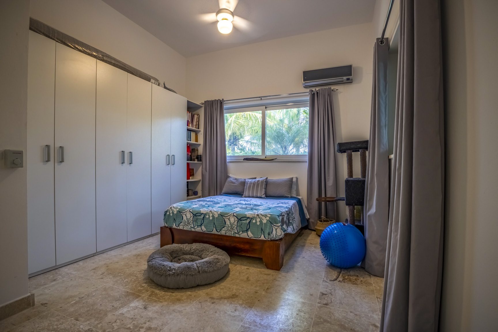 buyDRproperty Cozy small bedroom with large wardrobe, bed, and natural light. Bedroom design. Sosua Real Estate