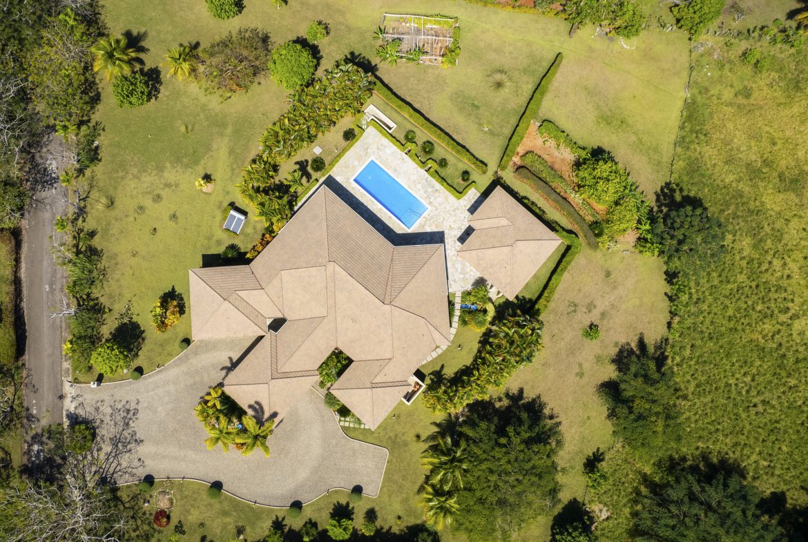 buyDRproperty Luxurious villa with pool in landscaped garden, aerial view Sosua Real Estate