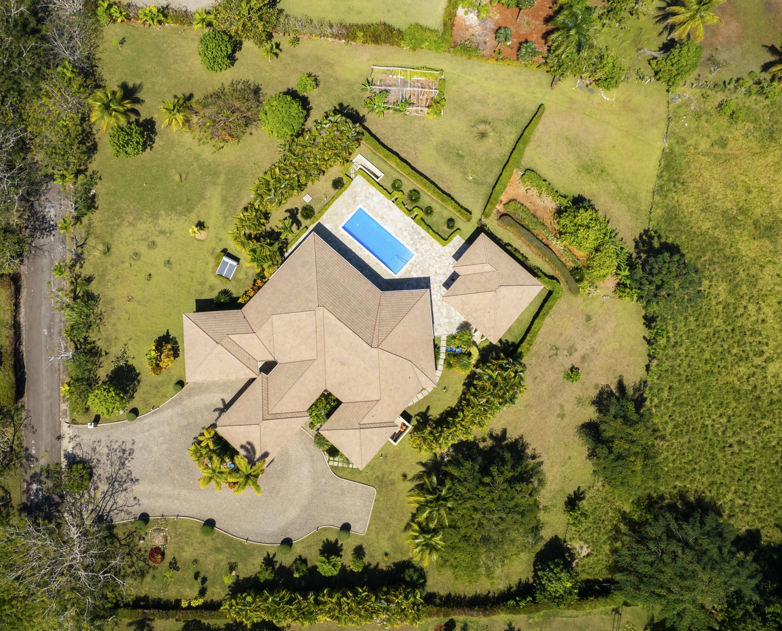buyDRproperty Luxurious villa with pool in landscaped garden, aerial view Sosua Real Estate