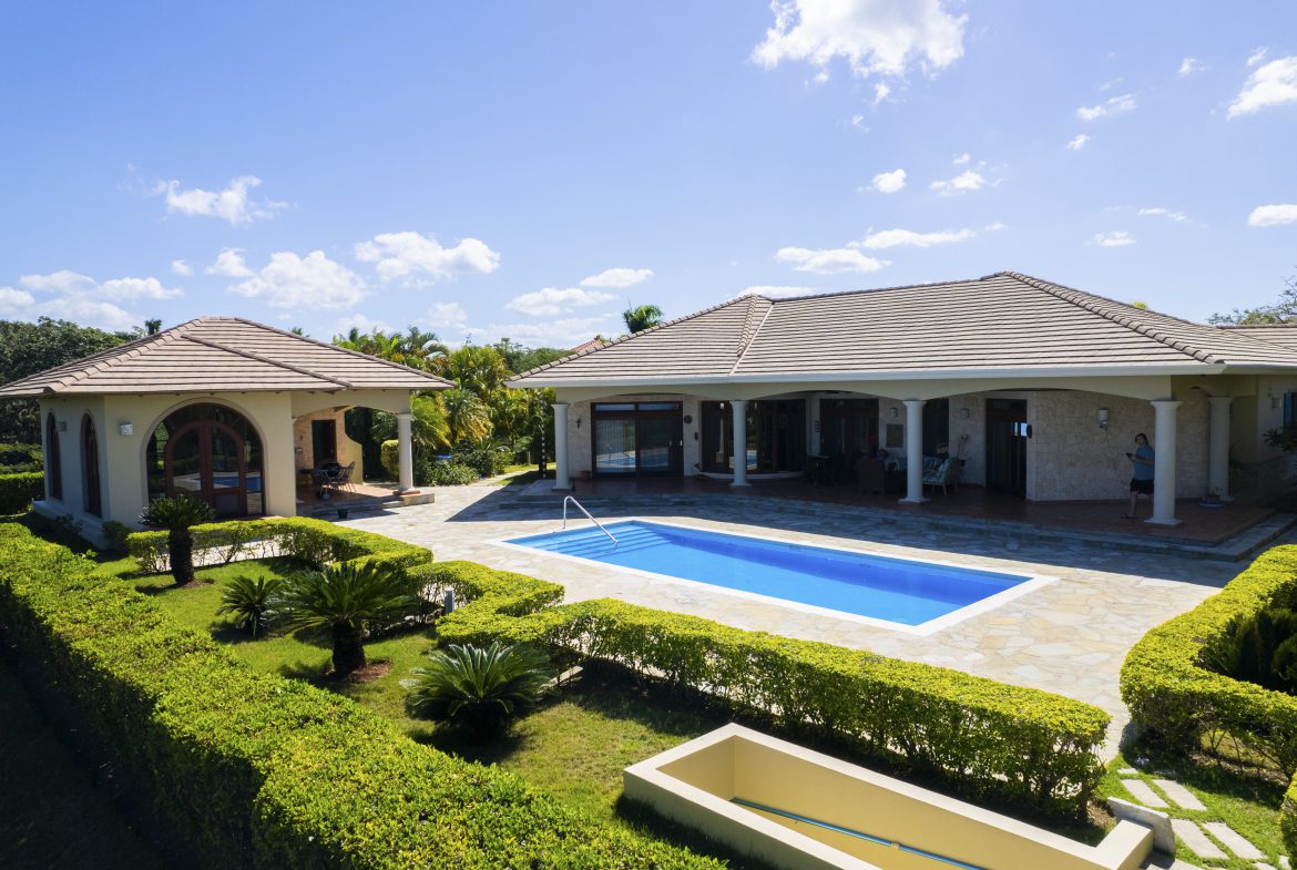 buyDRproperty Luxurious villa with a pool and garden under a clear blue sky Sosua Real Estate