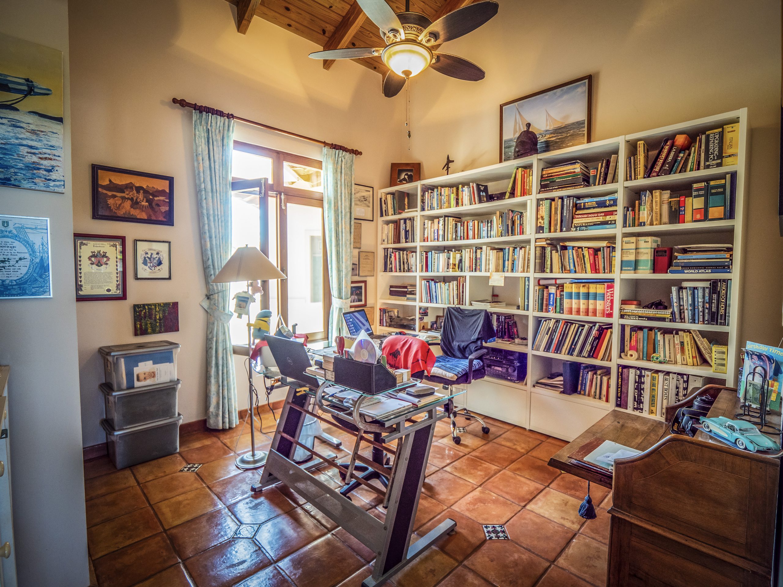 buyDRproperty Cozy home library with bookshelves and a sunny window Sosua Real Estate