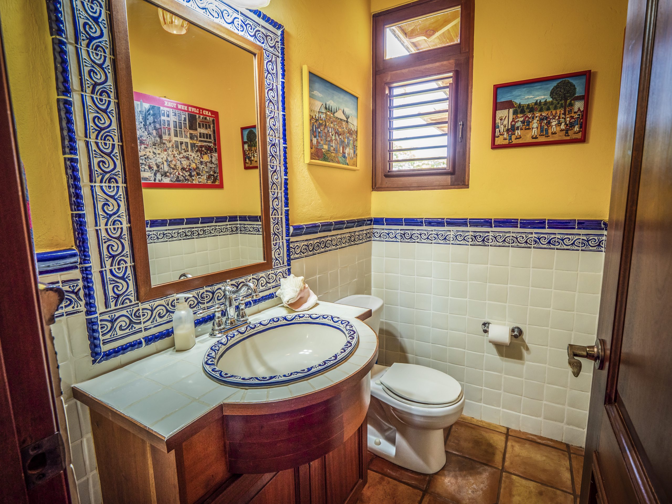 buyDRproperty Colorful bathroom with tiled sink and decorative wall art Sosua Real Estate