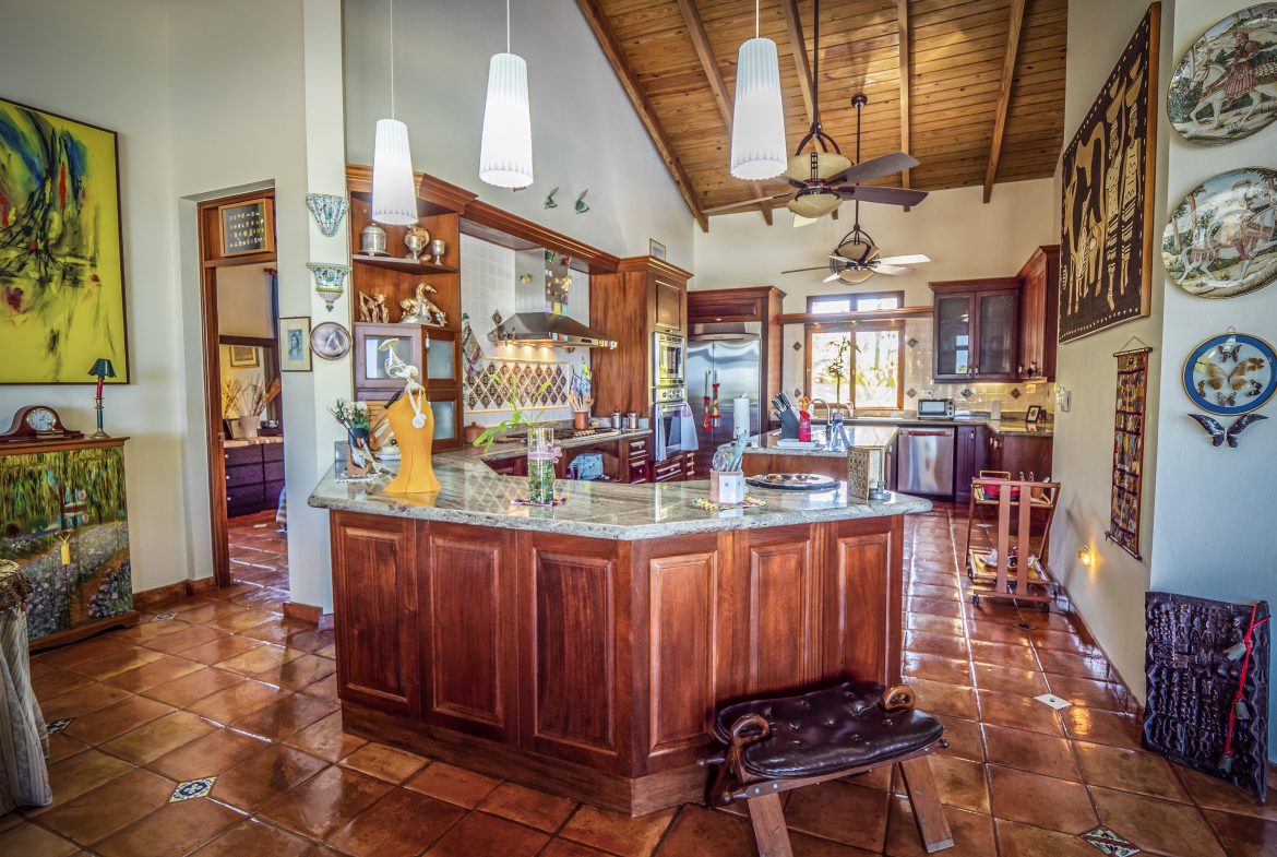 buyDRproperty Rustic kitchen with wooden cabinets and hanging lights Sosua Real Estate