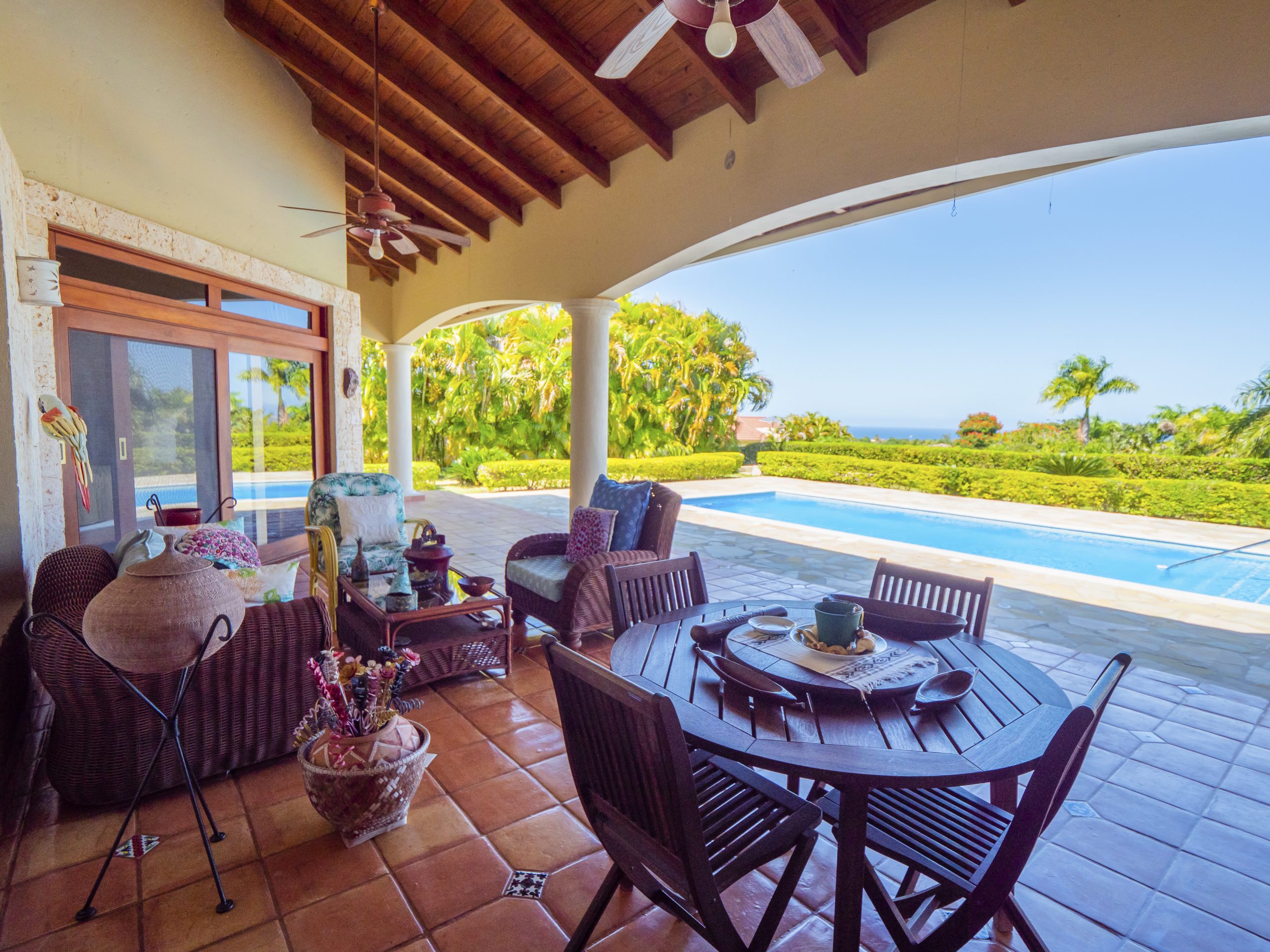 buyDRproperty Terrace with dining set overlooking pool and garden Sosua Real Estate