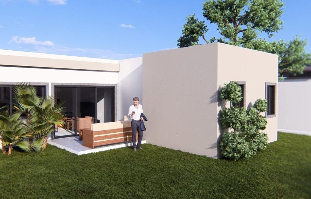 buyDRproperty Modern villa exterior with a man using his phone. Puerto Plata luxury villa for sale. Sosua Real Estate