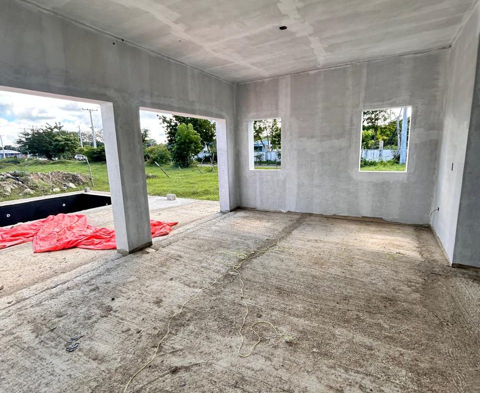 buyDRproperty Unfinished interior of a new house with concrete floors and walls, awaiting completion. Sosua Real Estate