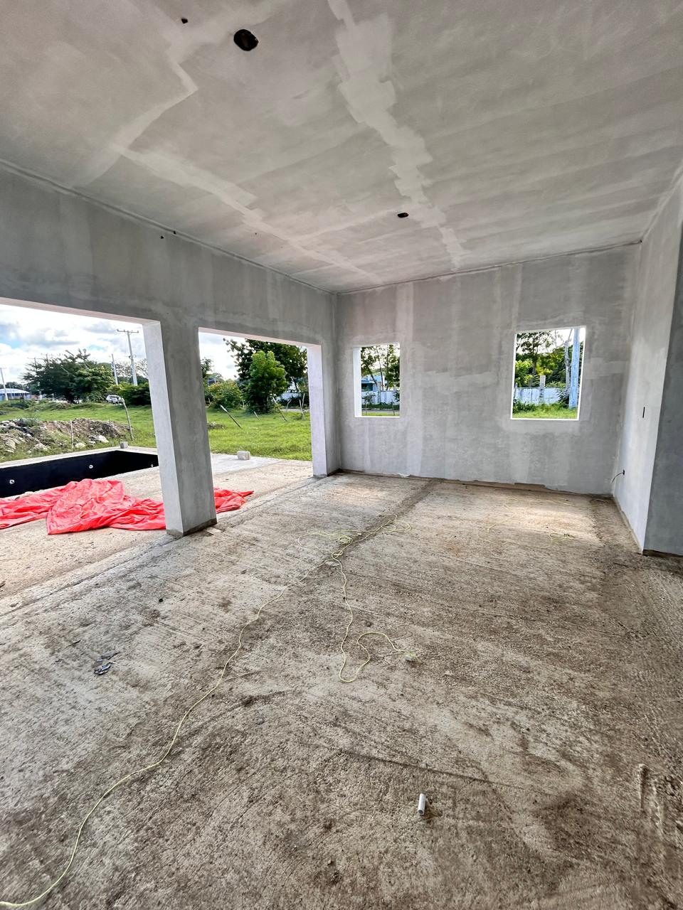 buyDRproperty Unfinished interior of a new house with concrete floors and walls, awaiting completion. Sosua Real Estate