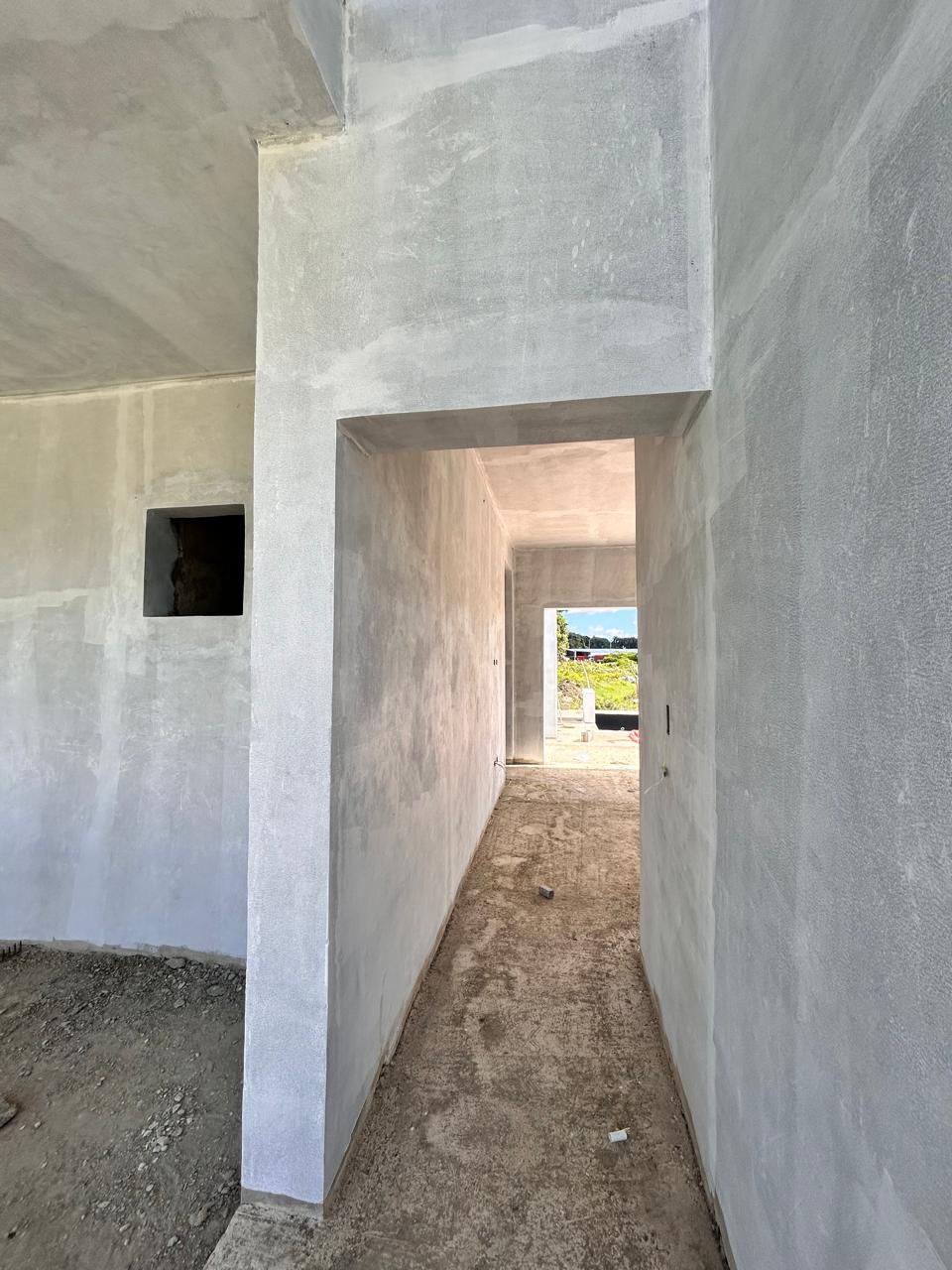 buyDRproperty Unfinished interior of a building with concrete walls and a doorway leading to an outdoor area. Sosua Real Estate