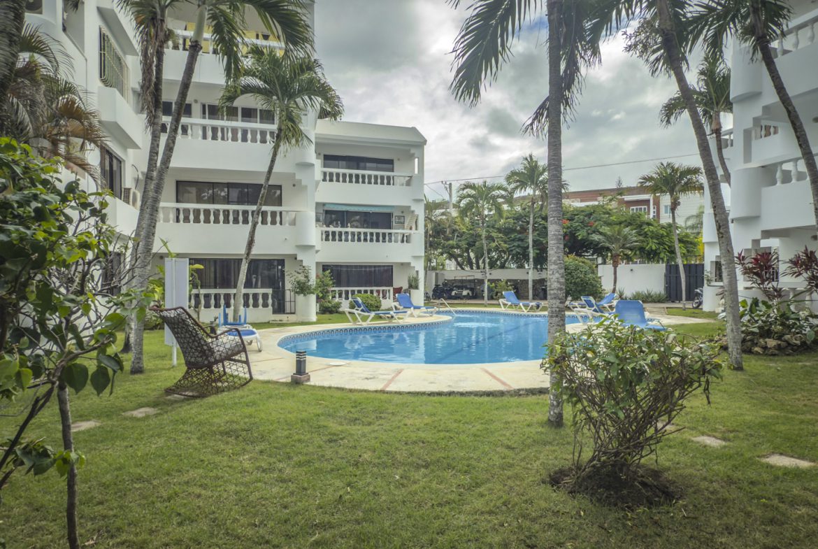 buyDRproperty Sosúa condo complex with pool and palm trees. Great value near the playa! Sosua Real Estate