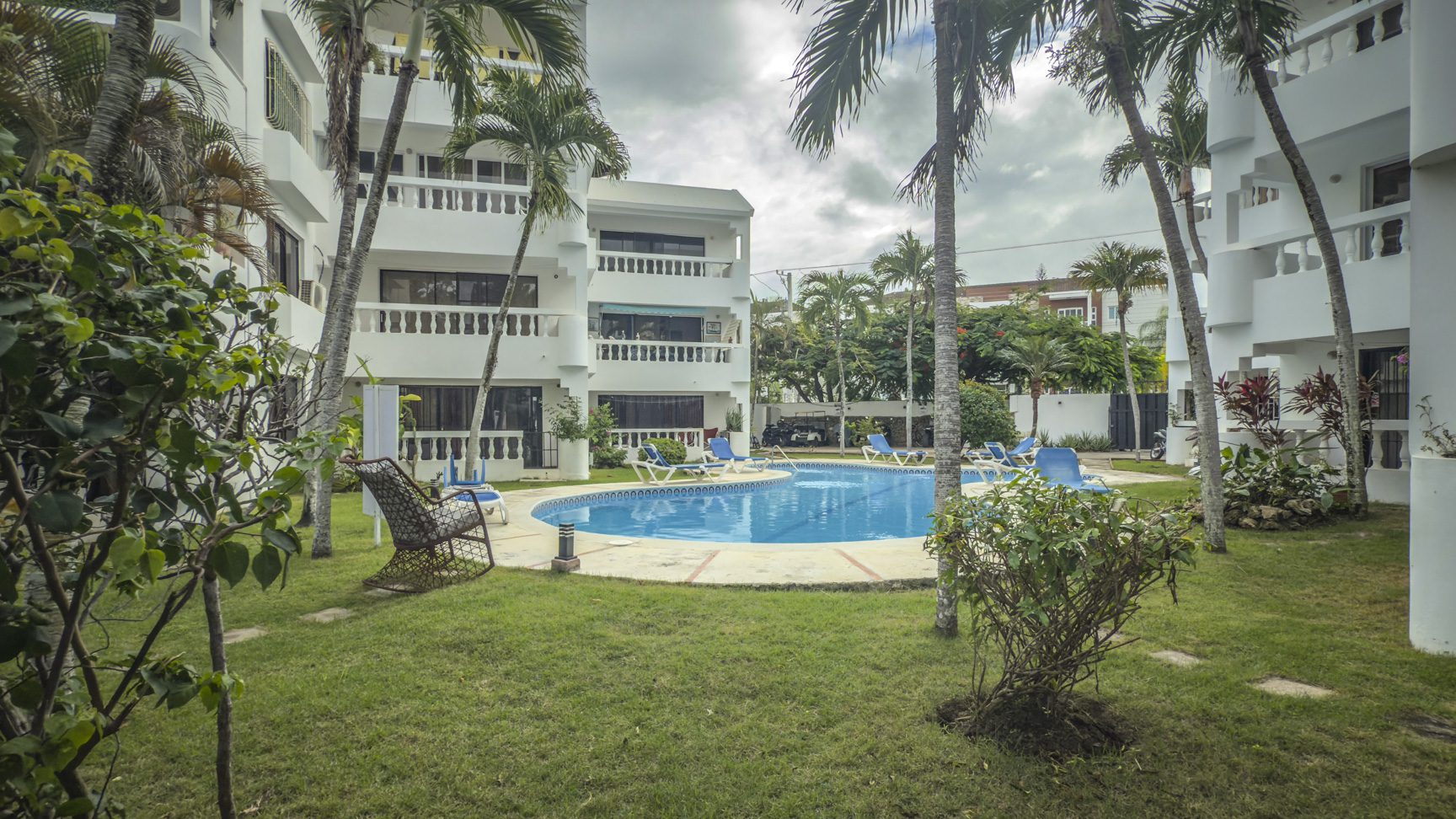 buyDRproperty Sosúa condo complex with pool and palm trees. Great value near the playa! Sosua Real Estate