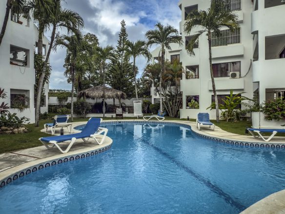 buyDRproperty Sosúa condo complex pool with lounge chairs; great value playa property. Sosua Real Estate