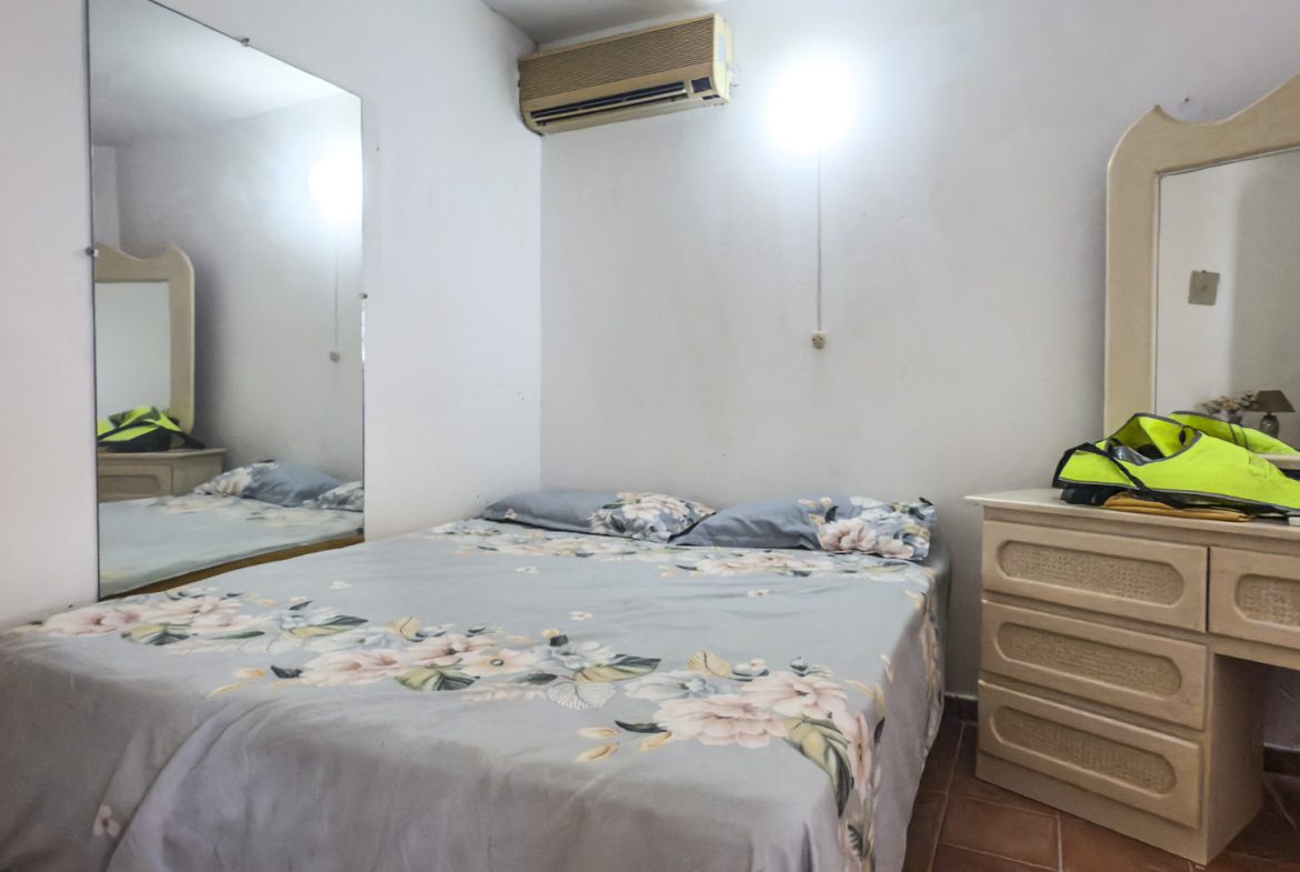 buyDRproperty Bedroom in Sosúa with bed, dresser, and mirror. Great value playa condo. Sosua Real Estate