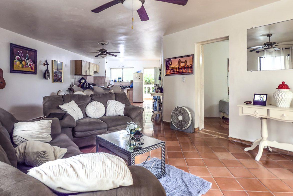 buyDRproperty Sosúa home interior with living room, kitchen, and dining area. Great value playa property. Sosua Real Estate