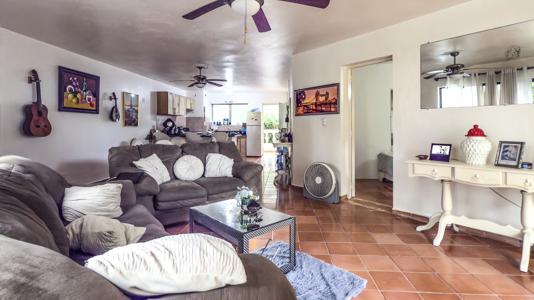 buyDRproperty Sosúa home interior with living room, kitchen, and dining area. Great value playa property. Sosua Real Estate