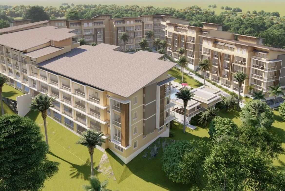 buyDRproperty Aerial view of a modern resort complex with multiple buildings, palm trees, and a swimming pool. Sosua Real Estate