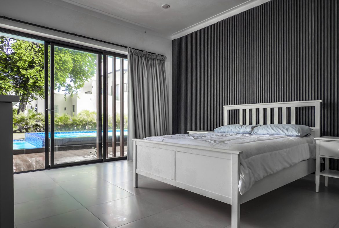 buyDRproperty Luxury villa bedroom with pool view, Sosua Ocean Village. Sosua Real Estate