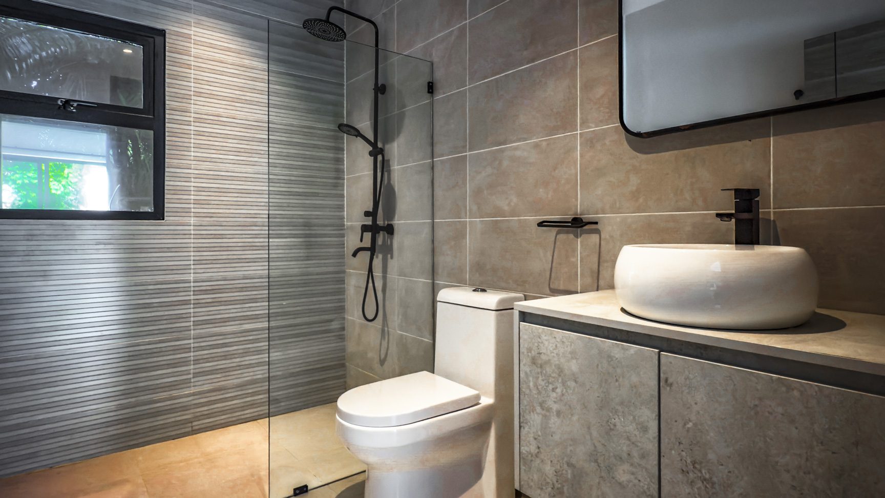 buyDRproperty Modern bathroom with shower, toilet, and sink in a luxury villa. Sosua Real Estate