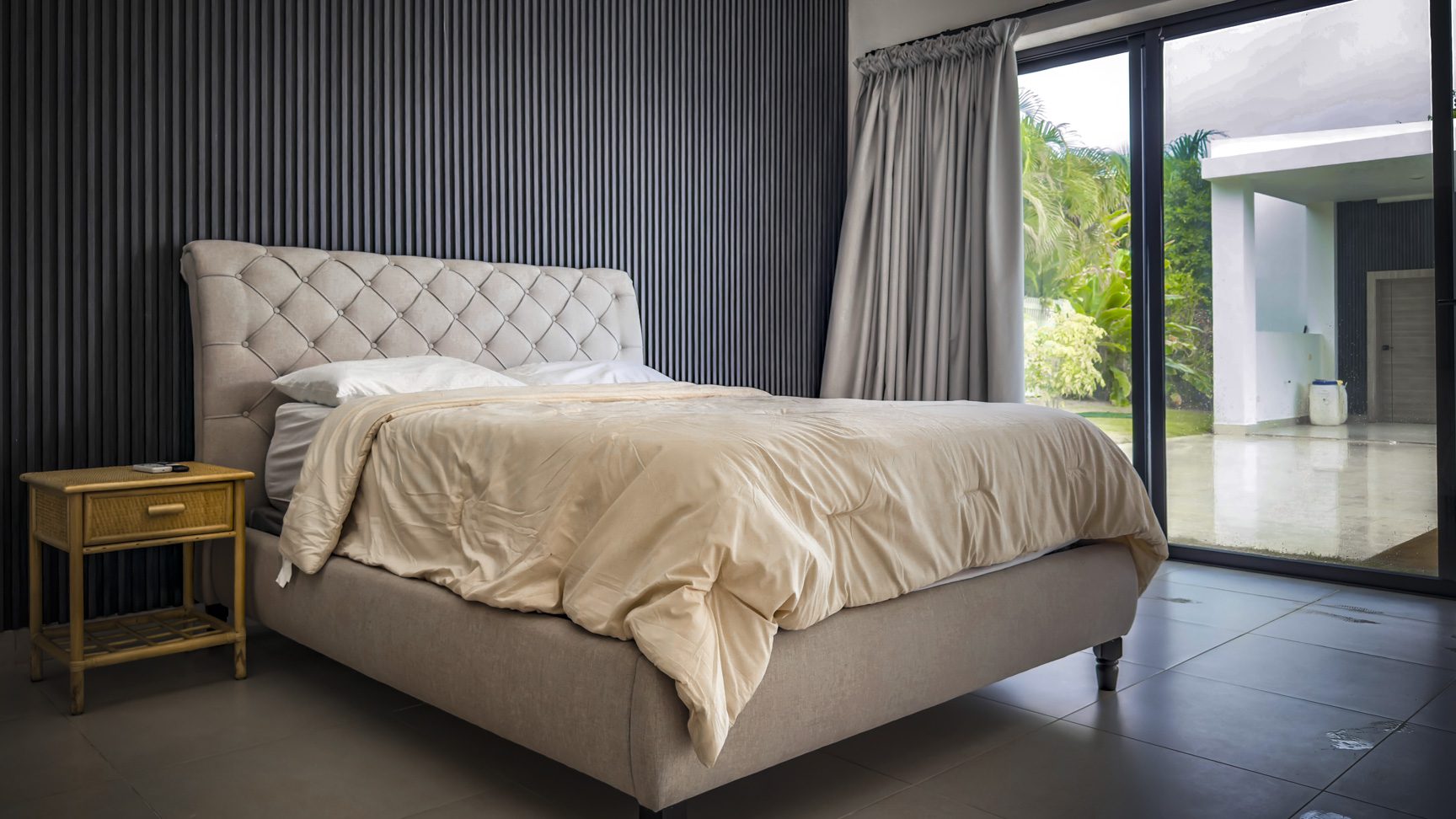 buyDRproperty Luxury bedroom with a tufted headboard in a Sosua Ocean Village villa for sale. Sosua Real Estate