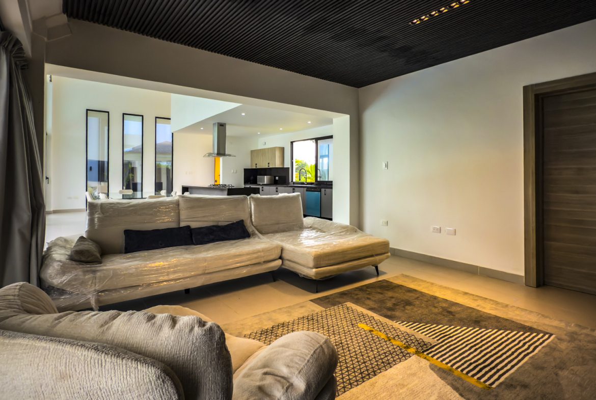 buyDRproperty Living room in a luxury villa for sale in Sosua Ocean Village, featuring modern design and open floor plan. Sosua Real Estate
