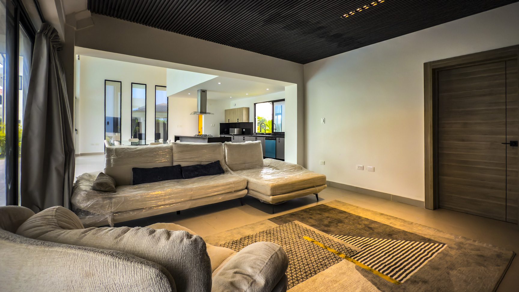 buyDRproperty Living room in a luxury villa for sale in Sosua Ocean Village, featuring modern design and open floor plan. Sosua Real Estate