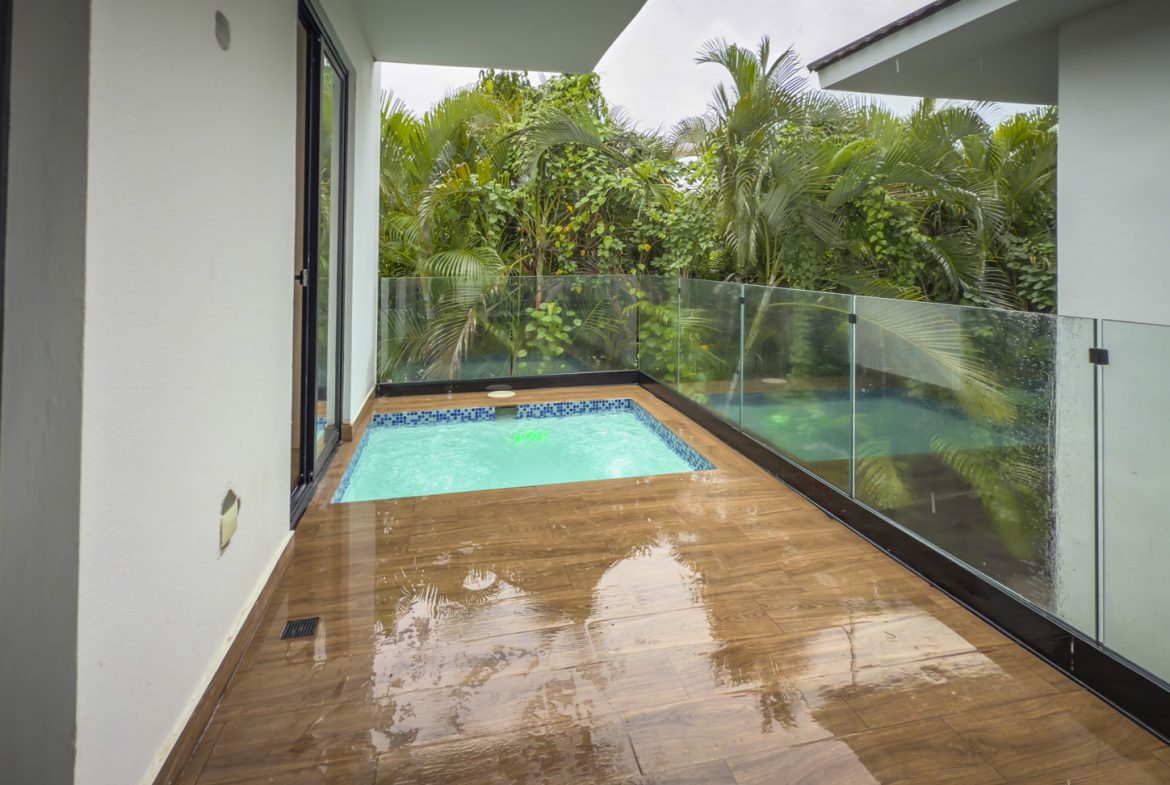 buyDRproperty Luxury villa balcony with small private pool and lush tropical greenery. Sosua Real Estate