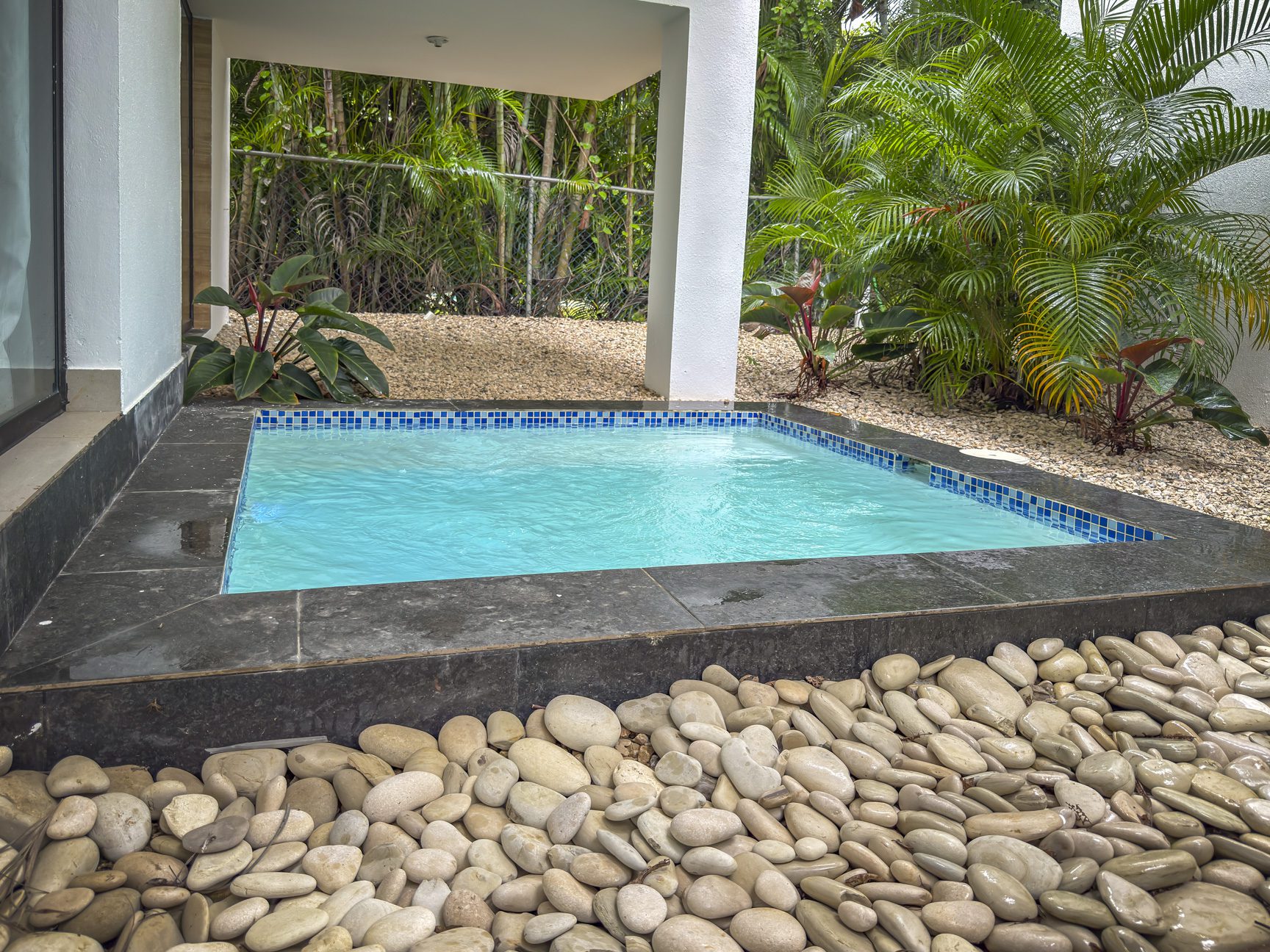 buyDRproperty Luxury villa splash pool with pebble surround and tropical landscaping. Sosua Real Estate