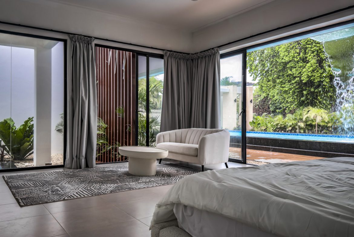 buyDRproperty Luxury villa bedroom with pool view in Sosua Ocean Village Sosua Real Estate