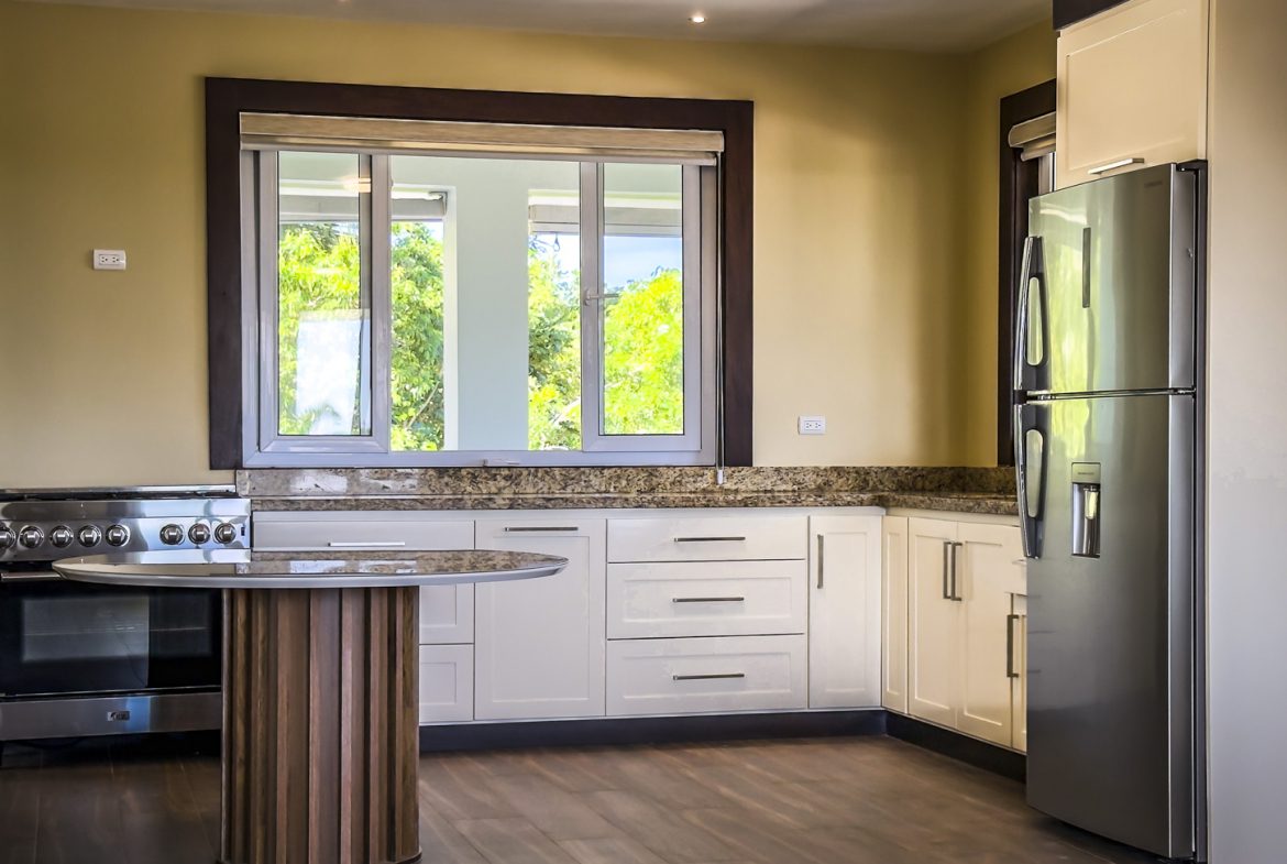 buyDRproperty Bright kitchen in 3-bedroom villa for sale in La Mulata, Dominican Republic. Features stainless steel appliances and granite countertops. Sosua Real Estate