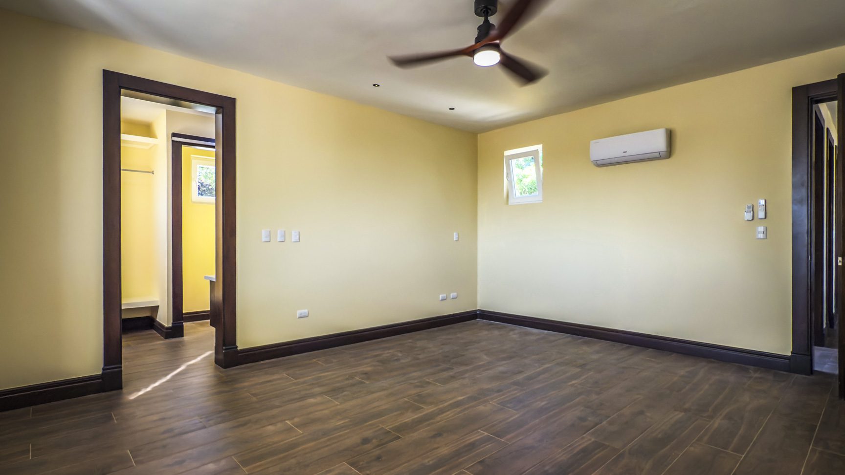 buyDRproperty Bedroom interior of 3 bedroom villa for sale in La Mulata, with hardwood floors and dark wood trim. Sosua Real Estate