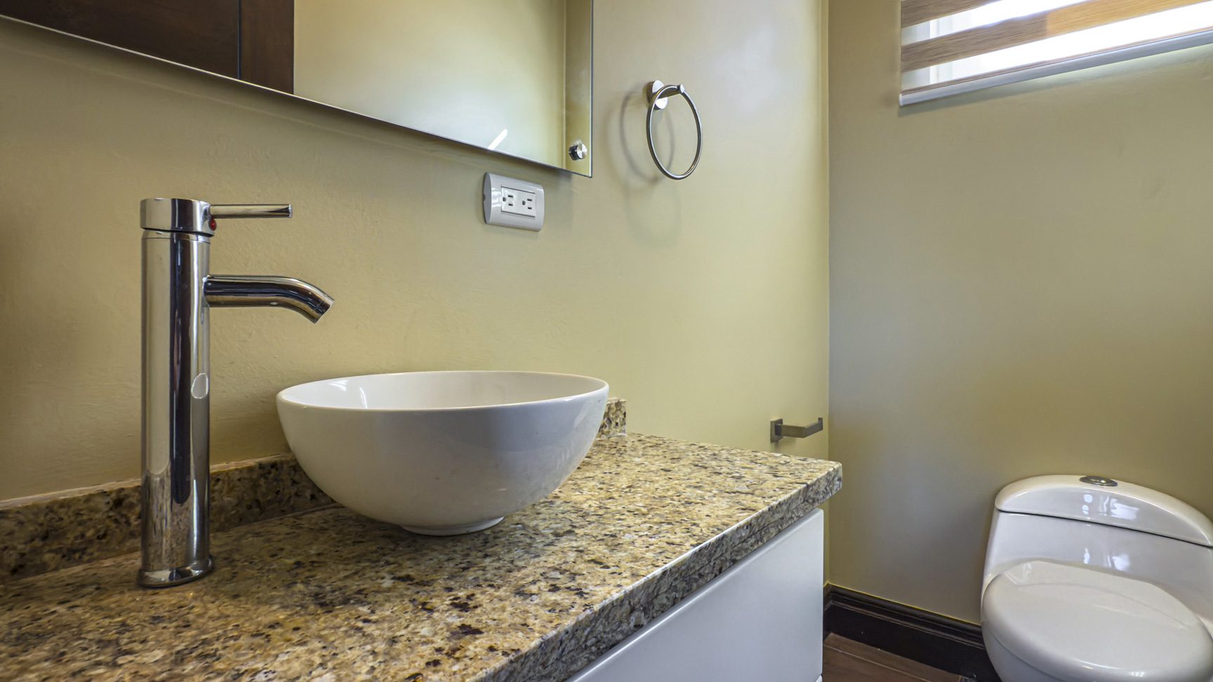 buyDRproperty Modern bathroom with vessel sink, granite countertop, and toilet. For sale villa in La Mulata. Sosua Real Estate