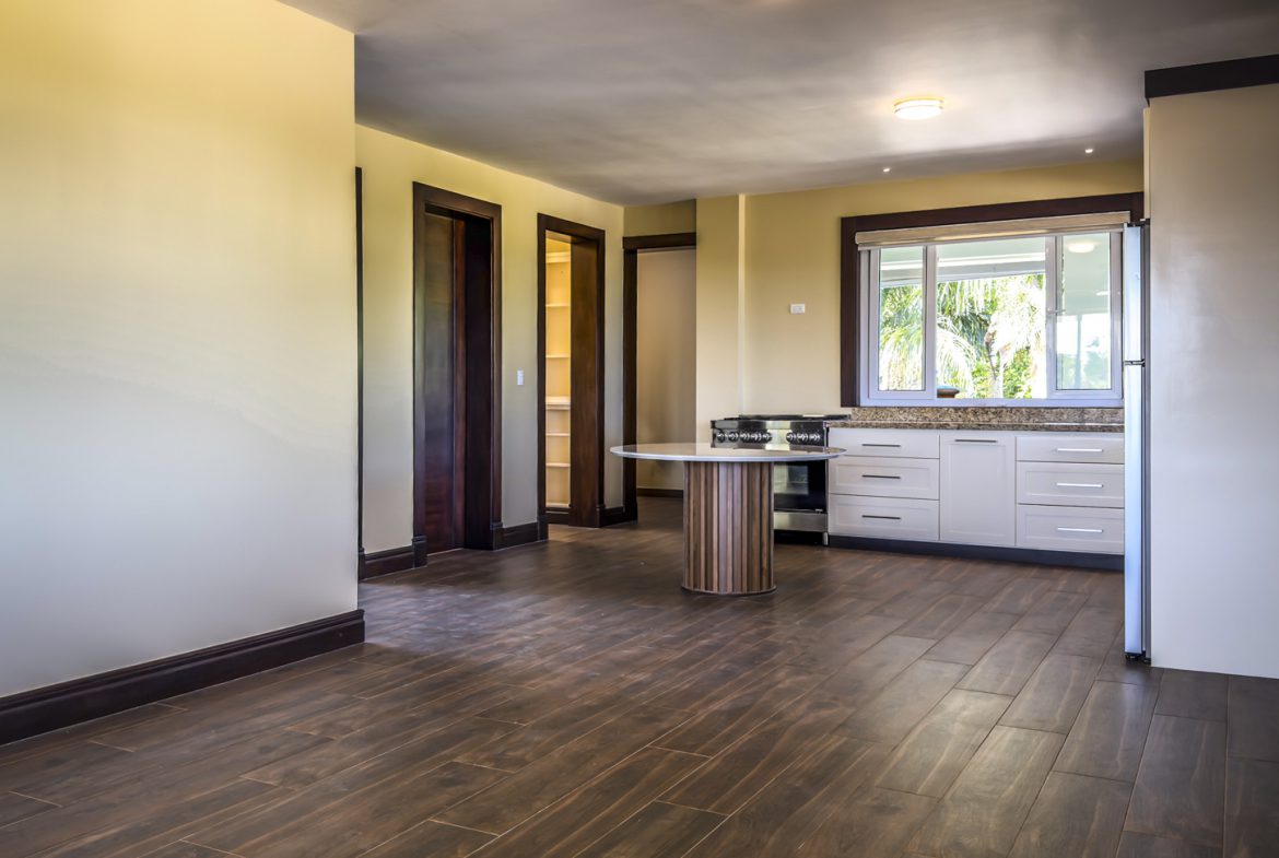buyDRproperty Interior view of a 3 bedroom villa in La Mulata, showcasing kitchen and dining area with wood floors. Sosua Real Estate